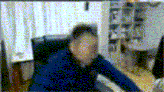 a blurry picture of a man sitting in a chair .