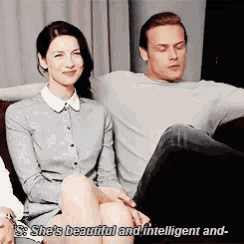 a man and a woman are sitting on a couch and the woman is saying she 's beautiful and intelligent and .