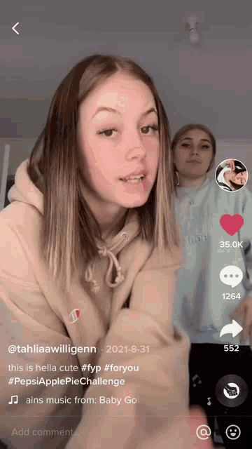 a screenshot of a tiktok video shows a girl in a champion sweatshirt