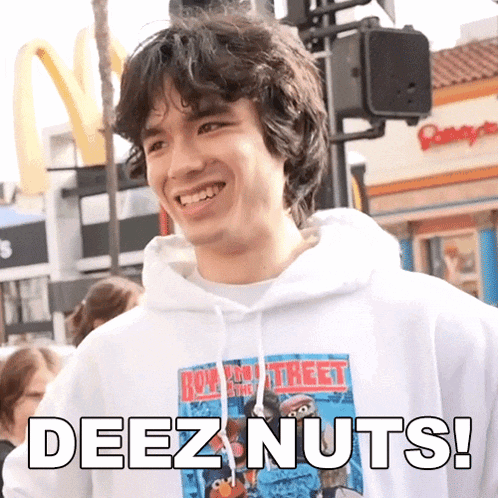 a young man wearing a hoodie that says deez nuts on it
