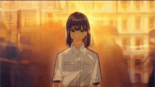 a girl with short hair and a white shirt stands in front of a building