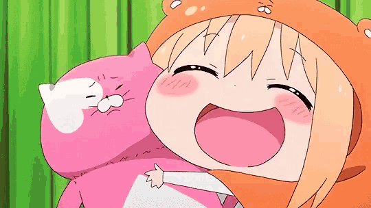 a girl in a bear hat is holding a pink stuffed animal .