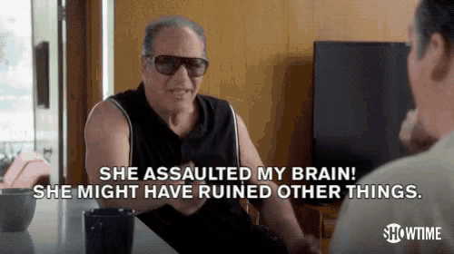 a man wearing sunglasses is talking to another man and says she assaulted my brain