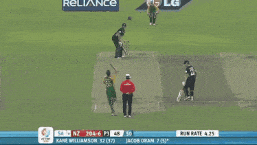 a cricket player is swinging a bat at the ball