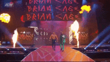 two men are walking down a stage with a sign that says brian < age