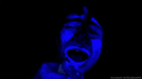 glow in the dark confetti is being thrown in a dark room