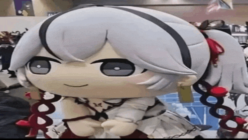 a stuffed toy of a girl with white hair and red flowers in her hair