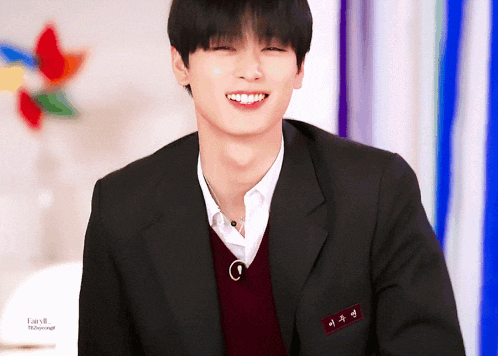 a young man in a school uniform is smiling with a name tag that says fairy8 on it
