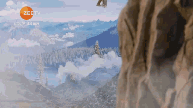an advertisement for zee tv shows a landscape of mountains and trees