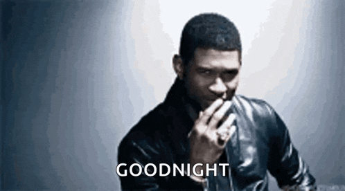 a man in a black leather jacket is smoking a cigarette and saying goodnight .