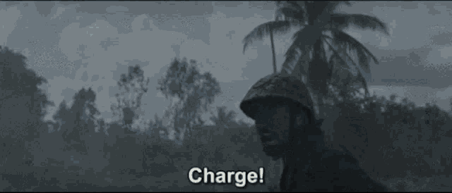 a soldier in a helmet is holding a gun in his hand and screaming .