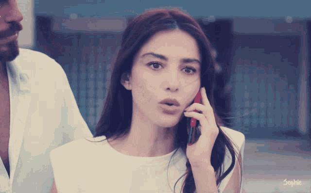 a woman talking on a cell phone with the name sophie on the bottom left