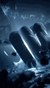 a close up of a person 's hand breaking through a glass window .