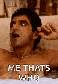a shirtless man is laying in a bathtub smoking a cigarette and says `` me thats who '' .