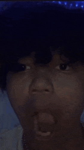 a young man with his mouth open looks up at something