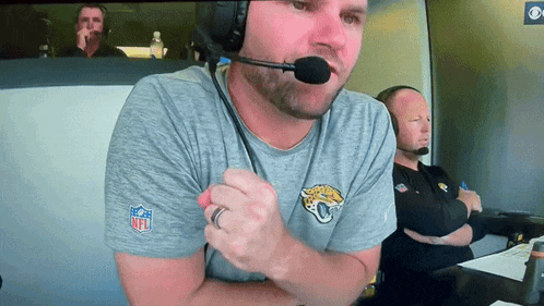a man wearing an nfl t-shirt with a jaguars logo on it
