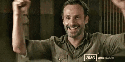 a man is smiling with his arms in the air .