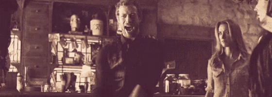 a man and a woman are standing next to each other in a kitchen .
