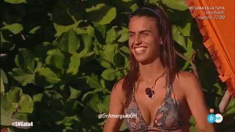 a woman in a bikini is smiling on a spanish tv show
