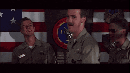 three men in military uniforms are standing in front of a united states flag