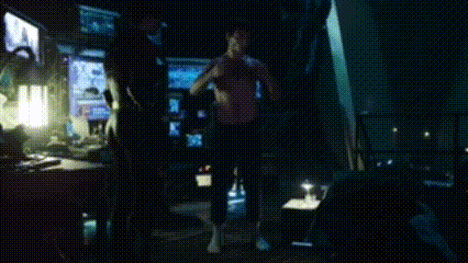 a blurry picture of people dancing in a dark room with a blue background