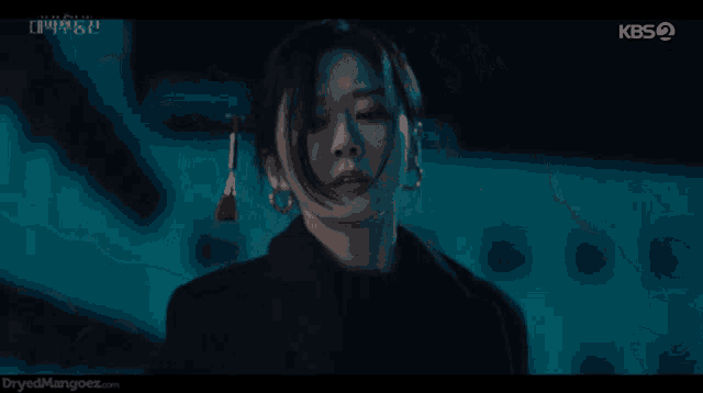a close up of a woman 's face with the kbs logo in the corner