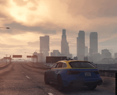 a car is driving down a highway with a city in the background