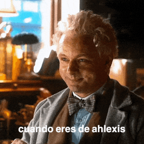 a man in a suit and bow tie is smiling and says cuando eres de ahlexis in spanish .