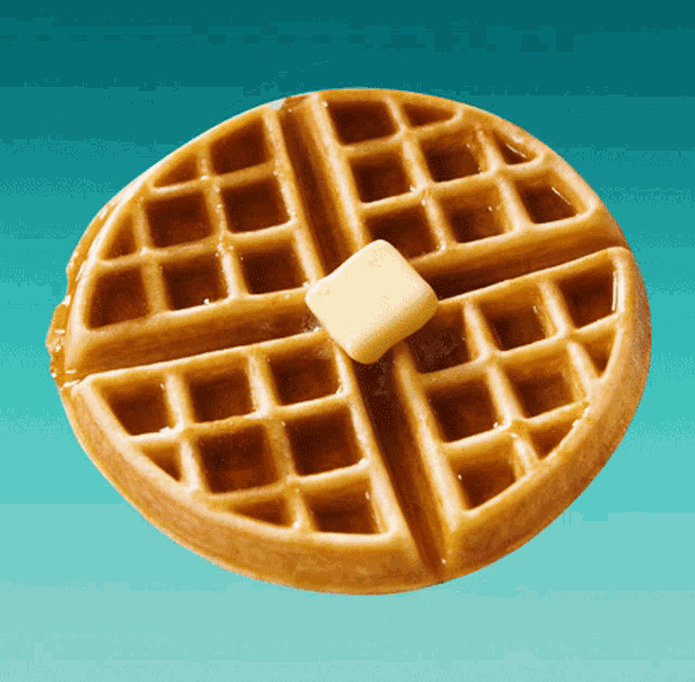 a waffle with syrup and butter on it on a blue background
