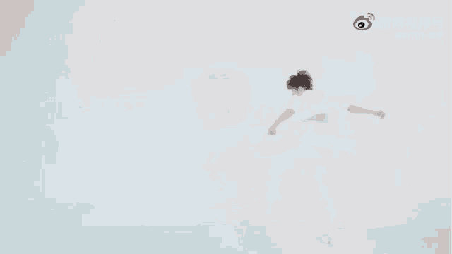a blurry picture of a man in a white shirt dancing in a room .