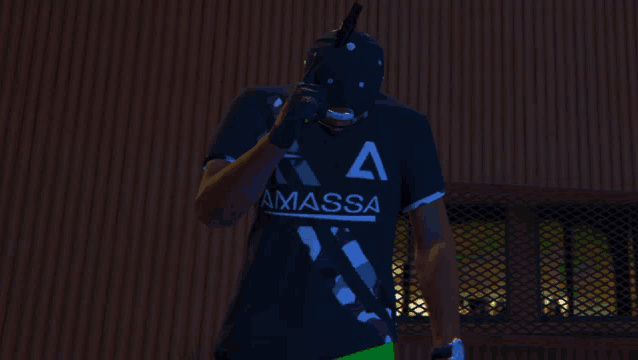 a man wearing a black shirt that says ammassa holds a gun