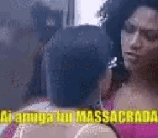 a woman in a pink tank top is talking to another woman in a pink tank top .