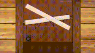 a cartoon drawing of a door with a cross drawn on it .
