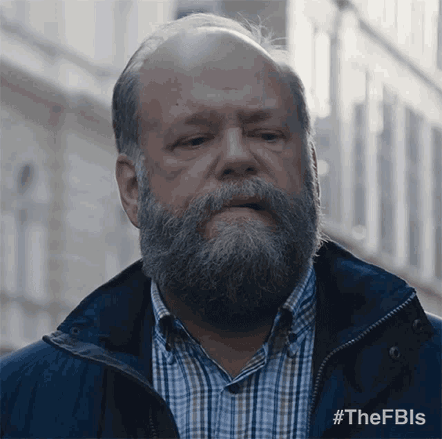 a man with a beard is wearing a blue jacket with the hashtag #thefbls