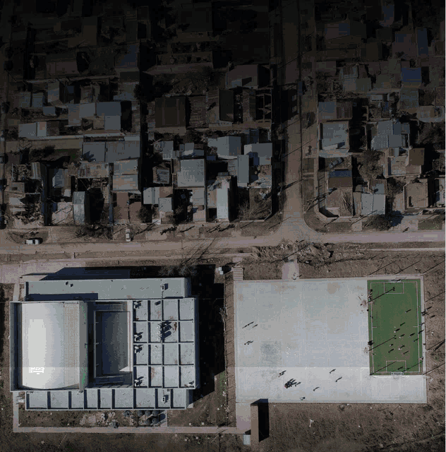 an aerial view of a soccer field and a swimming pool
