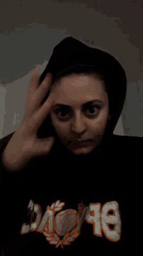 a person wearing a black hoodie that says ok