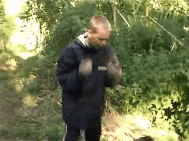 a man wearing a black jacket with the word puma on the front