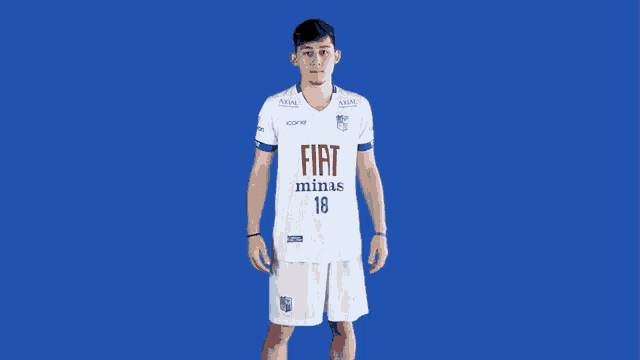 a man is wearing a white fiat minas 18 jersey