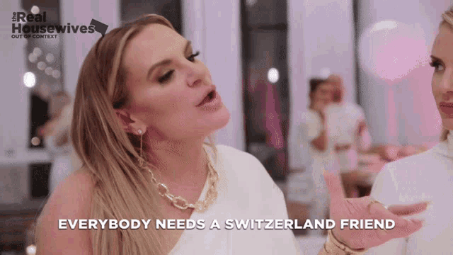a woman says everybody needs a switzerland friend in front of a pink background