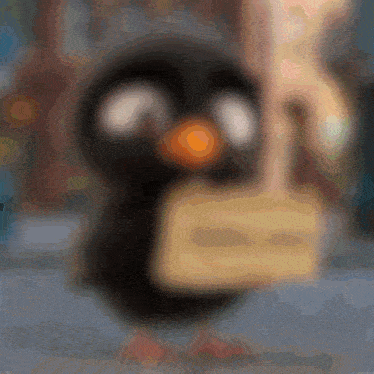 a blurry picture of a penguin holding a sign that says " i love you "