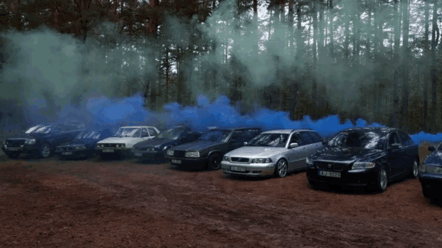 a row of cars with smoke coming out of them including a volvo with a license plate that says tb 912