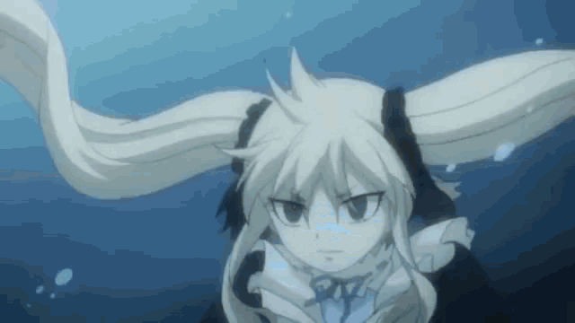 a girl with long hair is swimming in the ocean