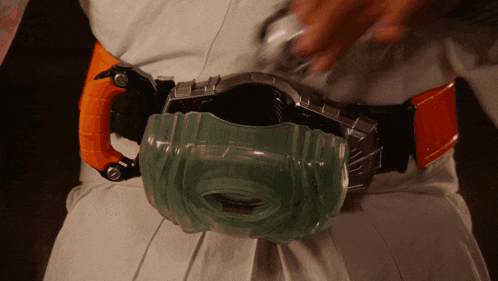 a close up of a person 's belt with a green object in it