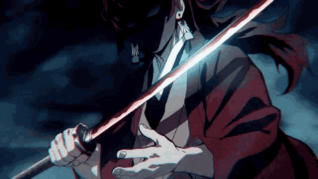 a man in a kimono is holding a sword in his hand .
