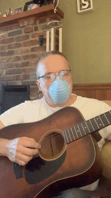 a man wearing a mask is playing a guitar