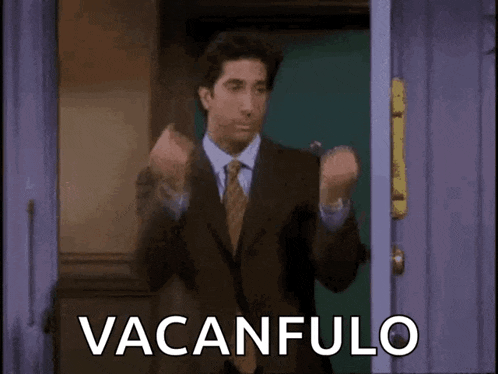 a man in a suit and tie is standing in front of a door with the words vacanfulo written on it .