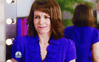 a woman in a blue shirt with a nbc logo on the sleeve