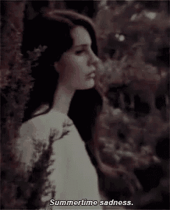 a woman in a white dress is standing in the woods with the words summertime sadness below her