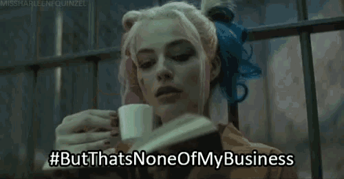 harley quinn is holding a cup of coffee and reading a book .