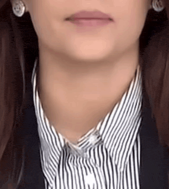 a close up of a woman 's neck and collar with a striped shirt and earrings .